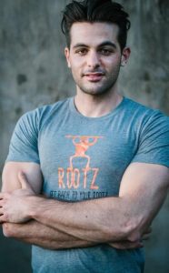 Harrison Levy, founder of Rootz Nutrition, wearing a Rootz t-shirt, symbolizing transparency and dedication behind the energizing superfood brand